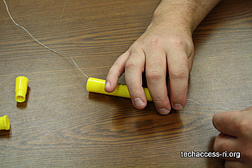 Photo of person putting wire through wide end of marker