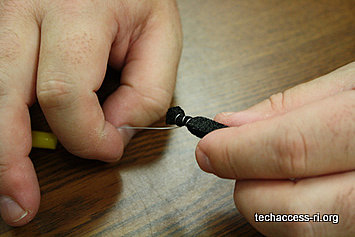 Photo of person wrapping wire around one end of a piece of conductive foam