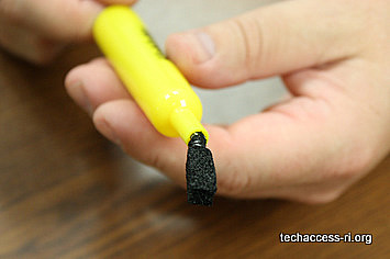 photo of person pulling wire and form through top of marker