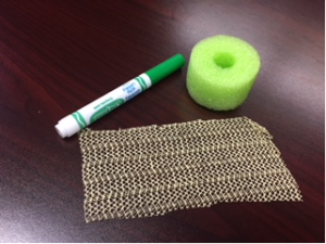 This is a picture of the materials needed: a cut pool noodle, shelf liner and a magic marker